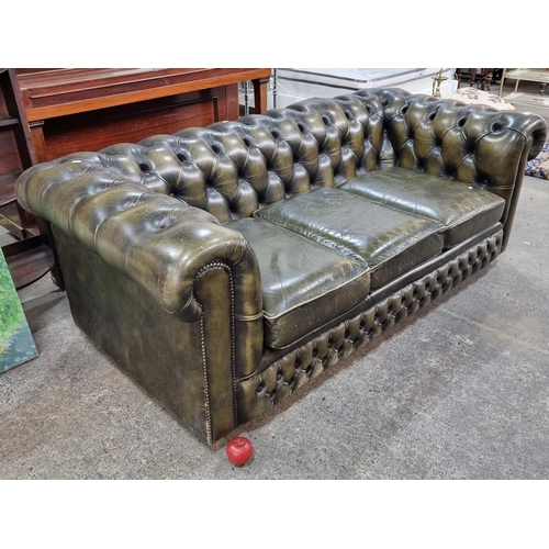 855 - Star Lot : A fabulous vintage Chesterfield  leather three-seater sofa with button back detailing to ... 