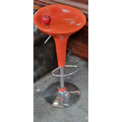 873 - A Retro style bar stool in a bright orange with molded seat and chrome footrest.