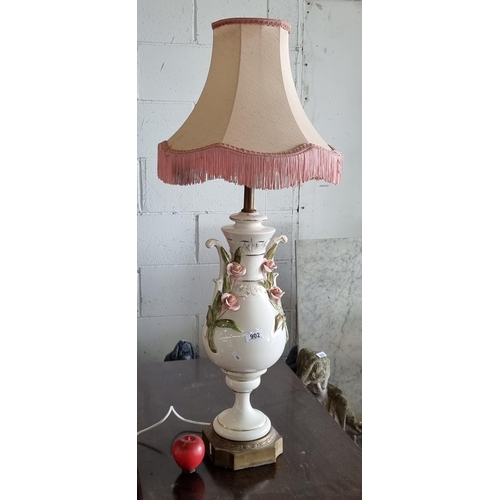 902 - A very tall and elegant vintage table lamp with a ceramic base in the form of an urn with high relie... 