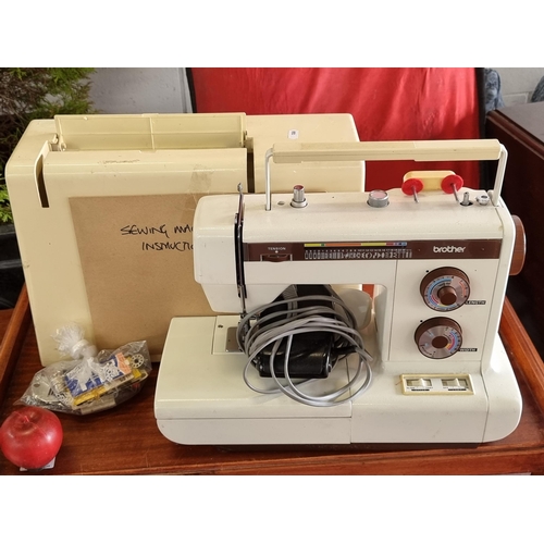 903 - A vintage Brother sewing machine model XL5001. With compartment to base filled with a collection of ... 