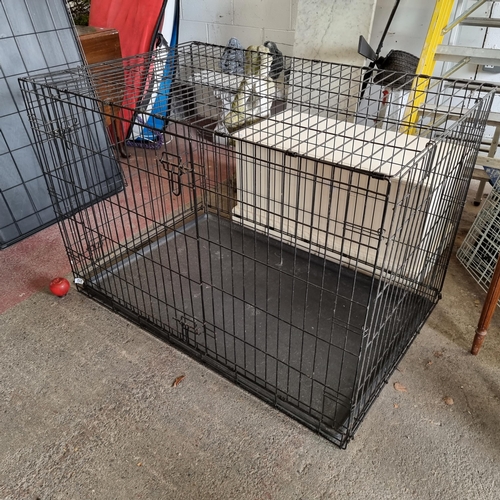 912 - A very large metal pet crate with removable plastic trays and hinged doors. Collapsible for easy sto... 