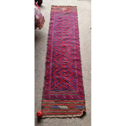 916 - Star Lot : A charming hand knotted wool hall runner rug featuring a geometric design in shades of re... 