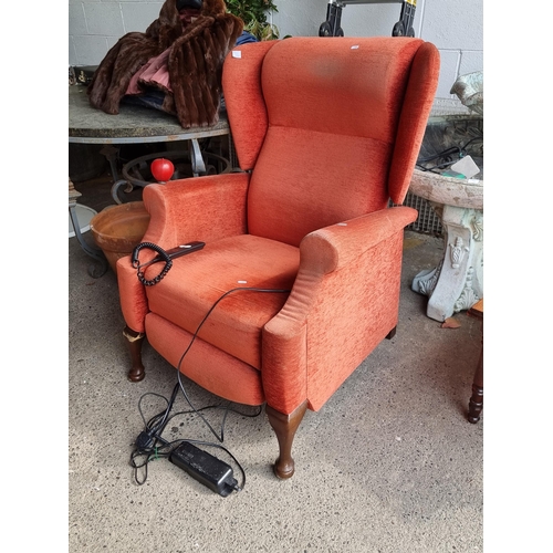 922 - A comfortable reclining wingback armchair from Irish brand The Back Shop. With controlled attached b... 