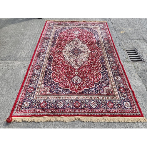 Star lot : A large elegant wool rug with a rich floral design in