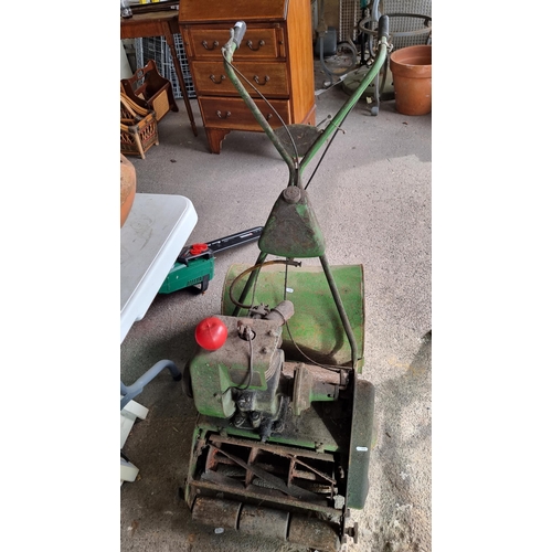 927 - A vintage cylinder lawn mower with petrol engine and grass box.  This is the type they use on cricke... 