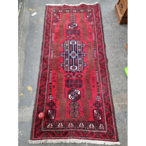 945 - Star Lot : A fabulous hand knotted Persian woolen hall runner rug in a bright red persian design. Re... 