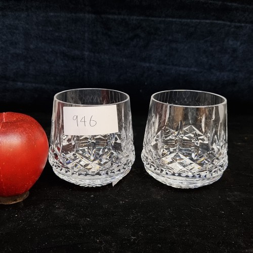 946 - Two Waterford Crystal tumblers in the Lismore pattern. In good condition with acid mark to base and ... 