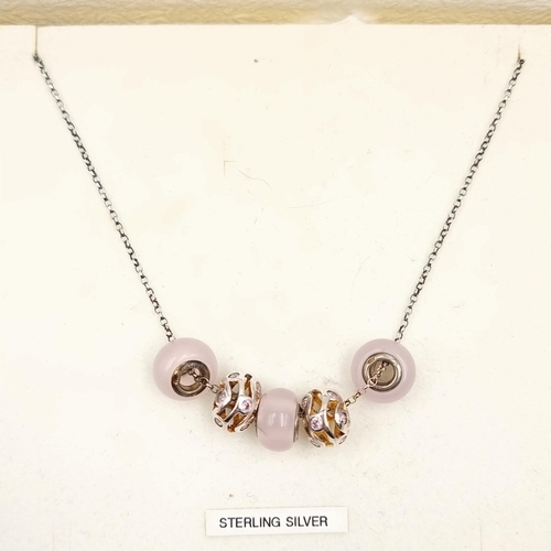 6 - A very pretty as new sterling silver charm necklace, set with polished stone and gem set accents. En... 