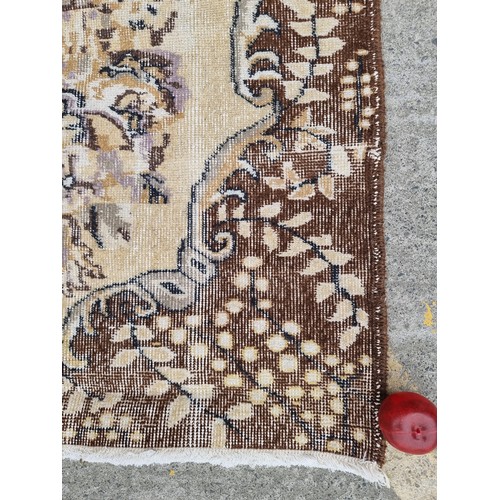 880 - Star Lot : A nice large, Vintage  hand made Handnotted Turkish wool on Cotton rug in shades of fawn,... 