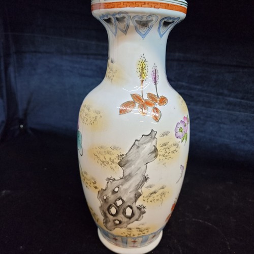 130 - A charming ceramic vase with hand painted scene of butterflies and foliate ornament in bright colour... 