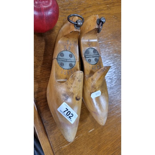 702 - A mixed lot of 13 items including two vintage wooden shoe molds, a vintage pulley, three lead weight... 