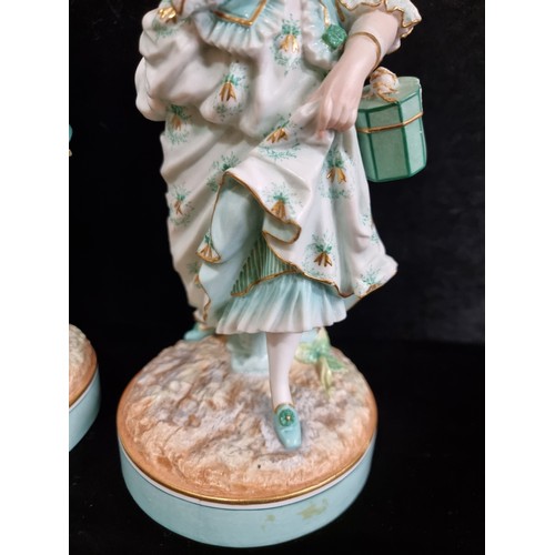 168 - Two vintage German bisque figures in 18th century dress in shades of turquoise and gilt. Stamped AM ... 