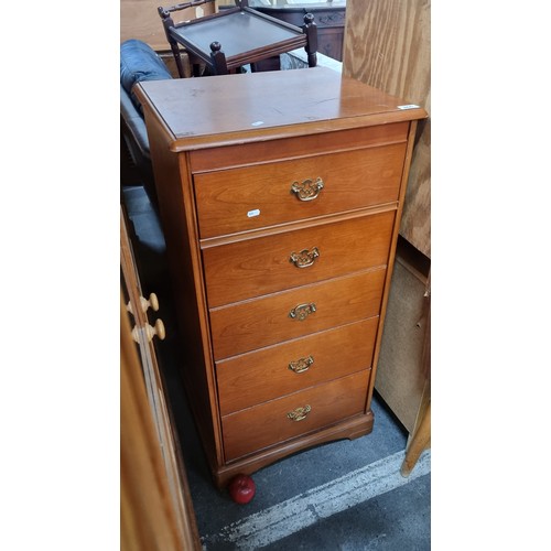 866 - A tallboy with five drawers with brass drop pull handles. The top lifts up to reveal a Mirror and sp... 