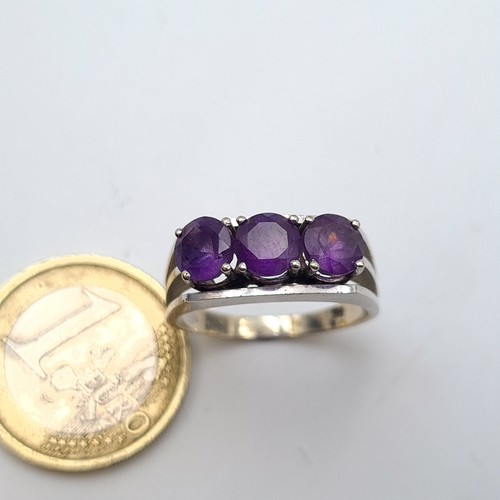 29 - Star Lot : A fabulous 14 carat marked White gold three stone Amethyst ring. This ring showcases larg... 