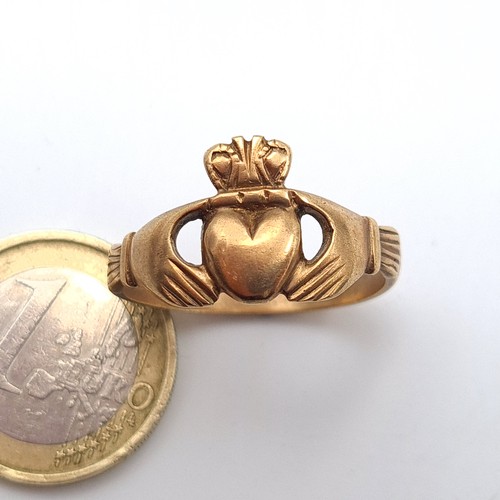 31 - A probable 9 carat gold Claddagh gent's ring, marked with stamp 