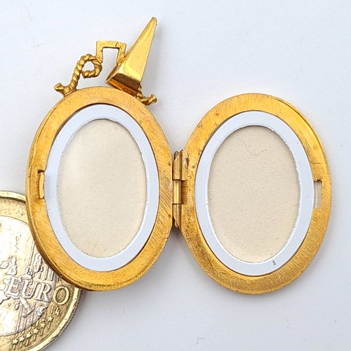 34 - Star lot : A beautiful and intricately formed antique 9 carat gold locket, set with a raised bright ... 