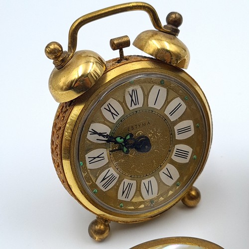 44 - A group of seven items, comprising of a stunning antique Estyla alarm travel clock, set with folaite... 