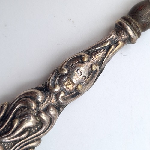 57 - A group of three antique sterling silver handled Repousse design boot hooks. Lengths:1 18cm and two ... 