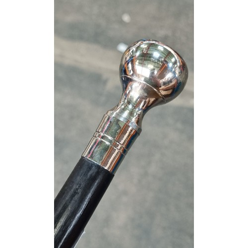 164 - A handsome walking cane with a polished steel pommel handle.