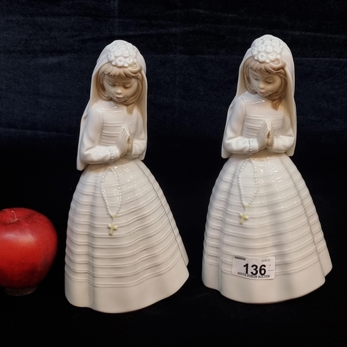 136 - A pair of Nao by Lladró porcelain sculptures designed to celebrate a girl's First Holy Communion. Th... 