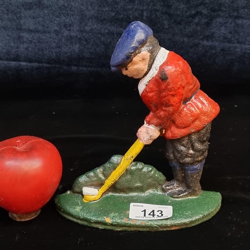 143 - A heavy cast metal golfer figure. Handpainted in a bright palette and freestanding.