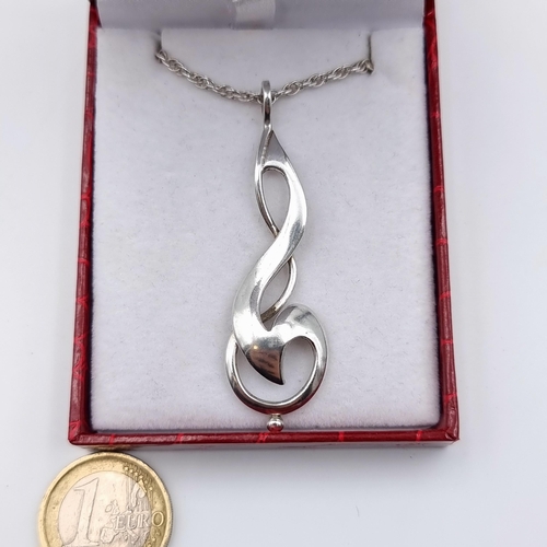 32 - A striking example of an abstract inspired sterling silver pendant and chain. Length of chain: 62cm.... 