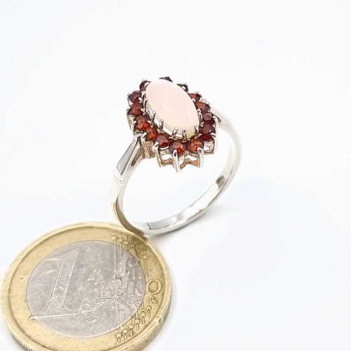 37 - A show stopping  Fire Opal and Ruby ring, this example features a generous central Fire Opal and a C... 