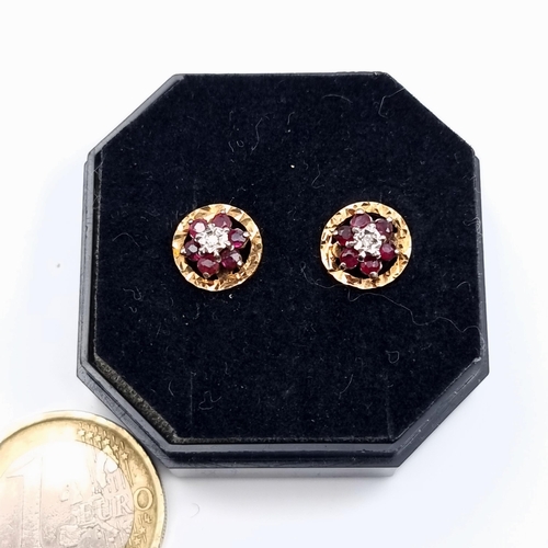 44 - Star Lot : A bright and shimmering pair of 9 carat gold Diamond and Ruby cluster set earrings. Total... 