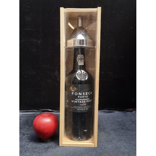 591 - A sealed 75cl bottle of Fonseca Porto Guimaraens Vintage Port from 1986, bottled in 1988 in a wooden... 