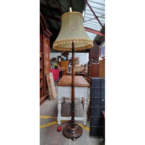 660 - A fabulous turned walnut floor lamp with acanthus leaf relief carving and bevelled circular base wit... 