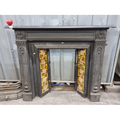 668 - A Victorian cast iron fireplace surround. Featuring an ornate surround with relief motifs such as sc... 