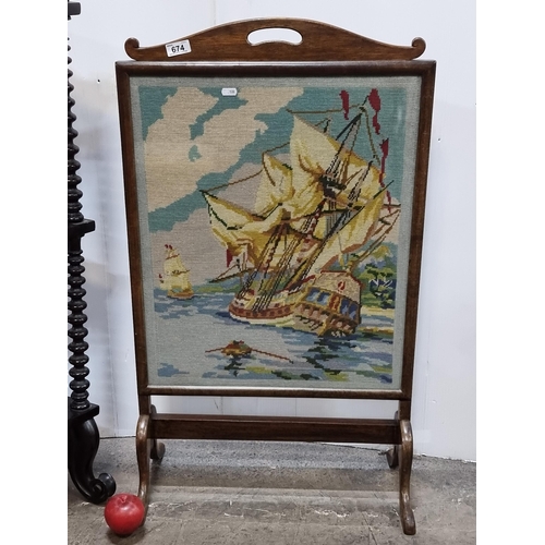 674 - A vintage fire screen with an embroidered central panel depicting a galleon ship. H92cm