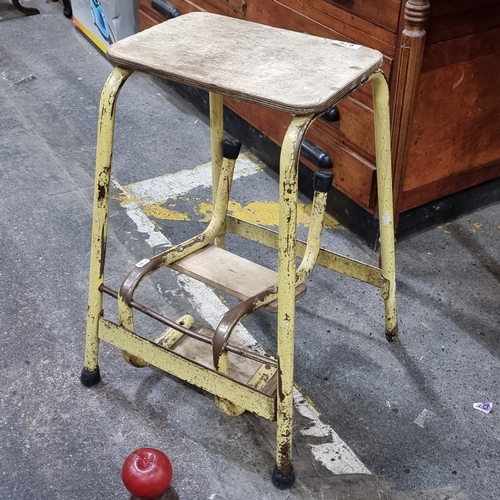 678 - A vintage stool which unfolds to reveal a step ladder with three wooden steps and metal tubular fram... 