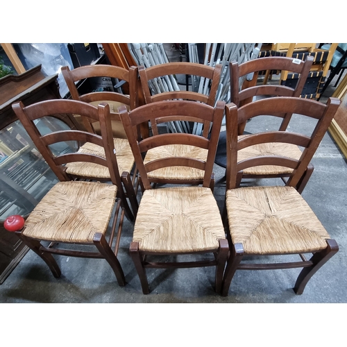 680 - Six charming ladderback dining chairs with woven sugan seats.