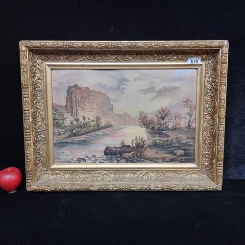 70 - Star Lot : An original oil on board painting featuring a large rock formation in the distance and a ... 