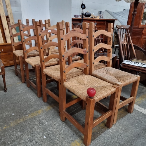 723 - A set of eight good quality ladderback dining chairs with woven sugan seats and large stud detailing... 