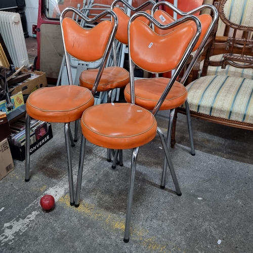 724 - A set of four super vintage dining chairs with tubular chrome frames and striking orange padded seat... 