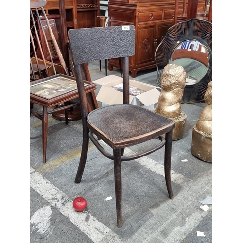 729 - A stylish vintage bistro chair with an unusual carved crocodile skin effect to backrest and seat. Se... 