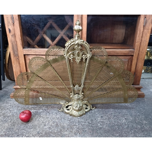 732 - A fabulous polished brass antique fire screen in a peacock fan form with pierced grate and highly or... 