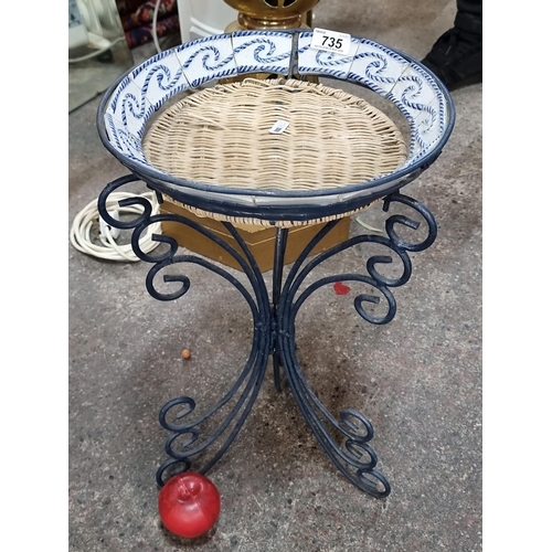 735 - A delightful vintage plant stand with wrought scroll frame, wicker basket and blue and white rope mo... 