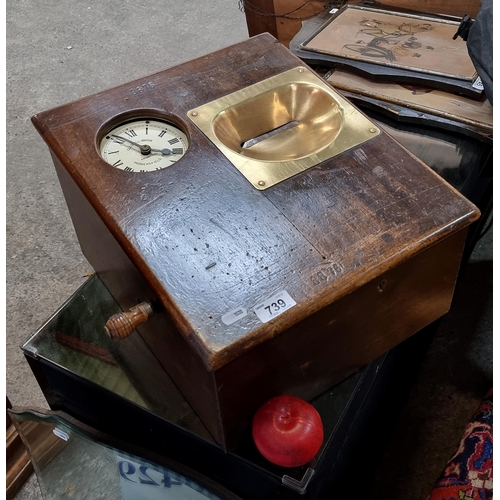 739 - An antique workplace clock in/ clock out machine, in a wooden frame and a Gledhill-Brook Huddersfiel... 