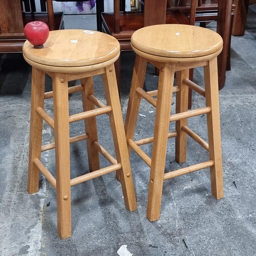 749 - Two charming wooden stools with a swivel top and turned wood stretchers.