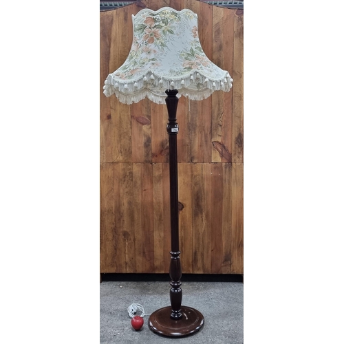 752 - A lovely tall floor standing lamp with turned wood stem and topped with a floral shade with tassel t... 