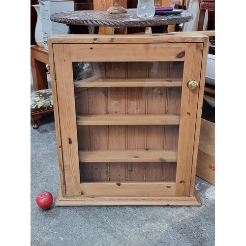 800 - A lovely clean example of a neatly proportioned pine cabinet; with glass door and three internal she... 