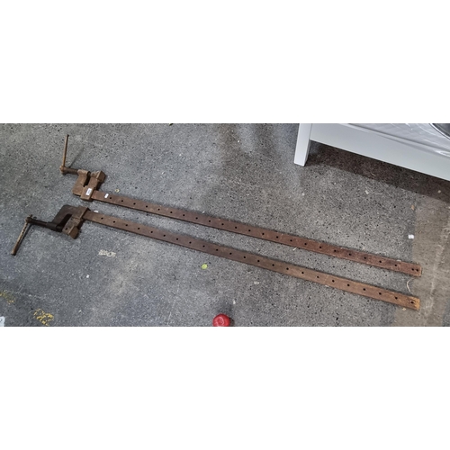 843 - Two very heavy and large cast metal furniture vice. A whopping 200cm long.