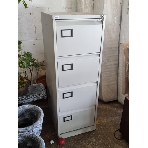 868 - A large clean metal filing cabinet with four drawers with label tags and original lock and key.