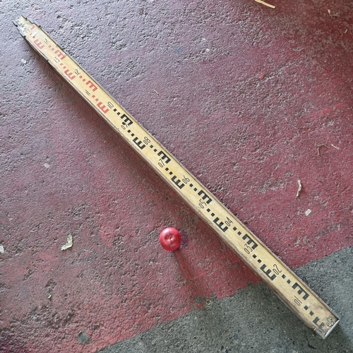 916 - A large antique two draw surveyor's measuring stick with brass fittings. Inscription to back reads 