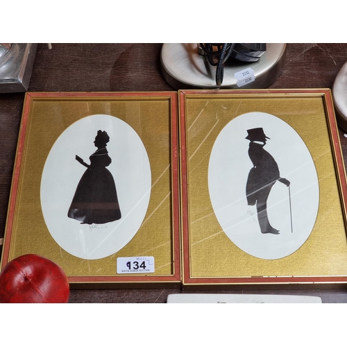 934 - A diptych pair of prints by artist James Price depicting black silhouettes of a lady and a gentleman... 