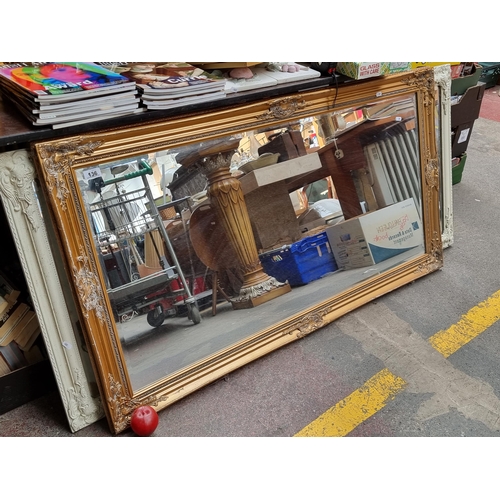 936 - Star lot : A large elegant rectangular over mantle mirror with bevelled glass and held in a gilt woo... 