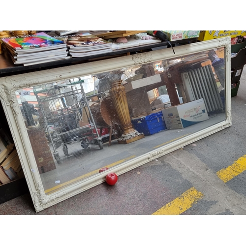 937 - Star lot : A very large rectangular wall mirror with bevelled glass and ornate wooden frame featurin... 